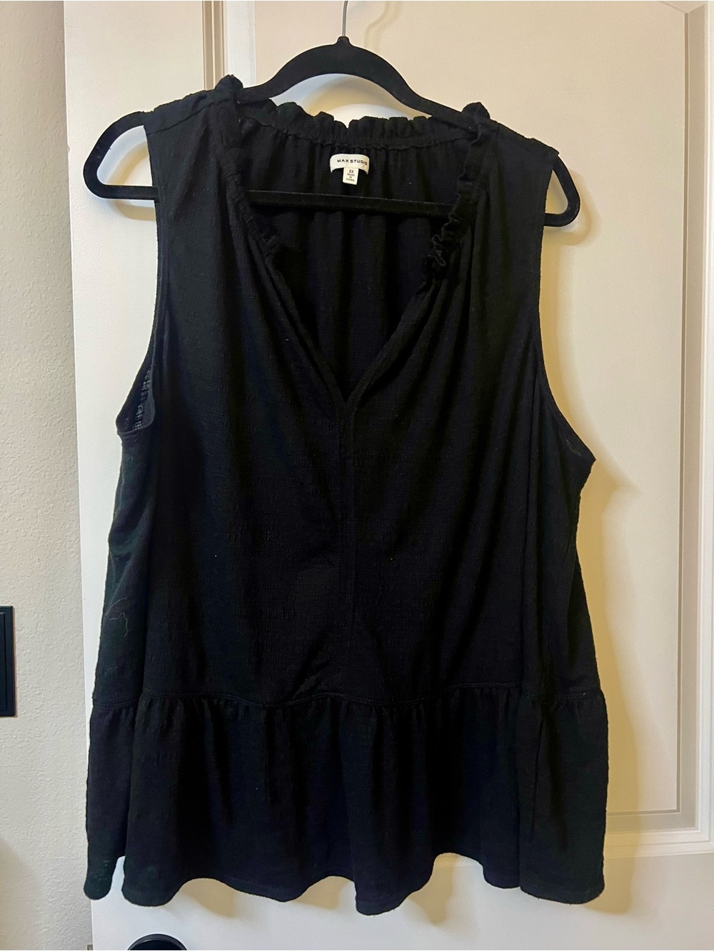 Sleeveless black tank with ruffle at bottom